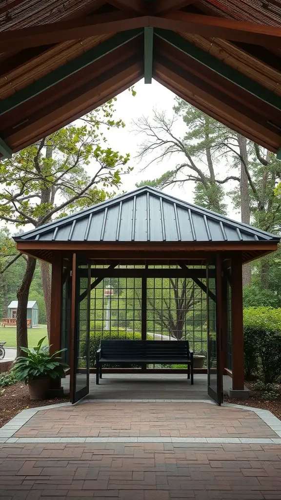 A pavilion with a wooden structure, featuring retractable screens, a bench, and surrounded by greenery.