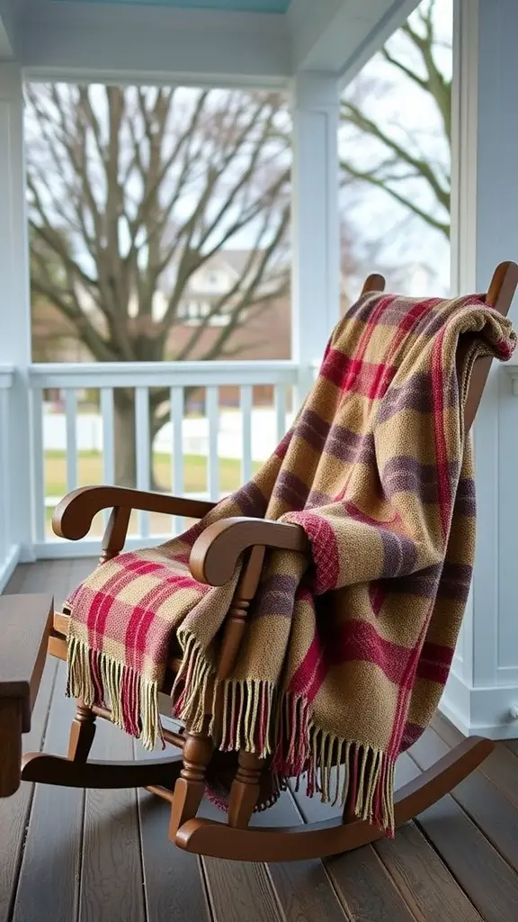 A cozy rocking chair with a plaid blanket on a farmhouse porch