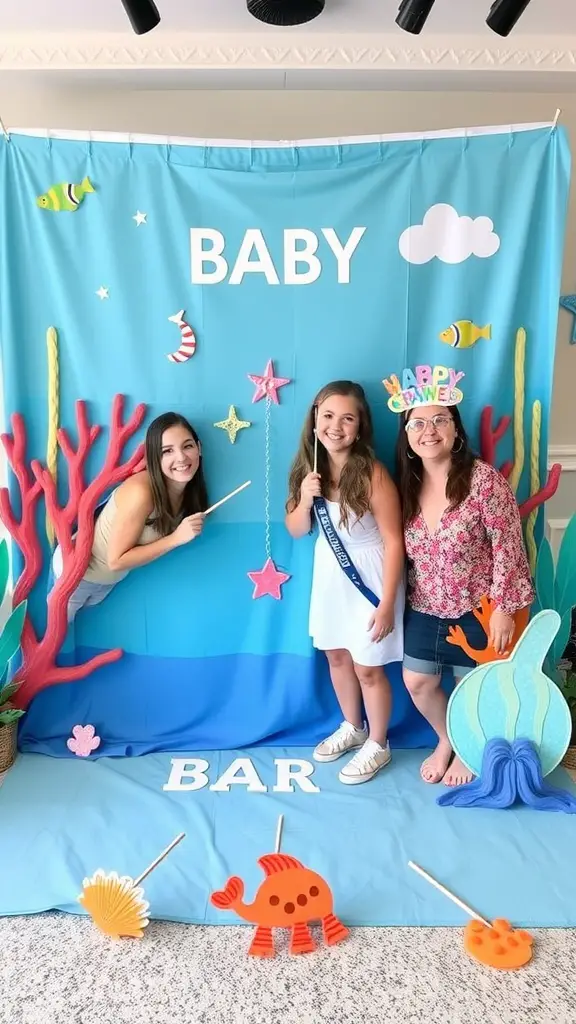 21 Coastal Baby Shower Theme Ideas You’ll Love 10 A coral reef themed photo booth at a baby shower with colorful decorations and smiling guests.