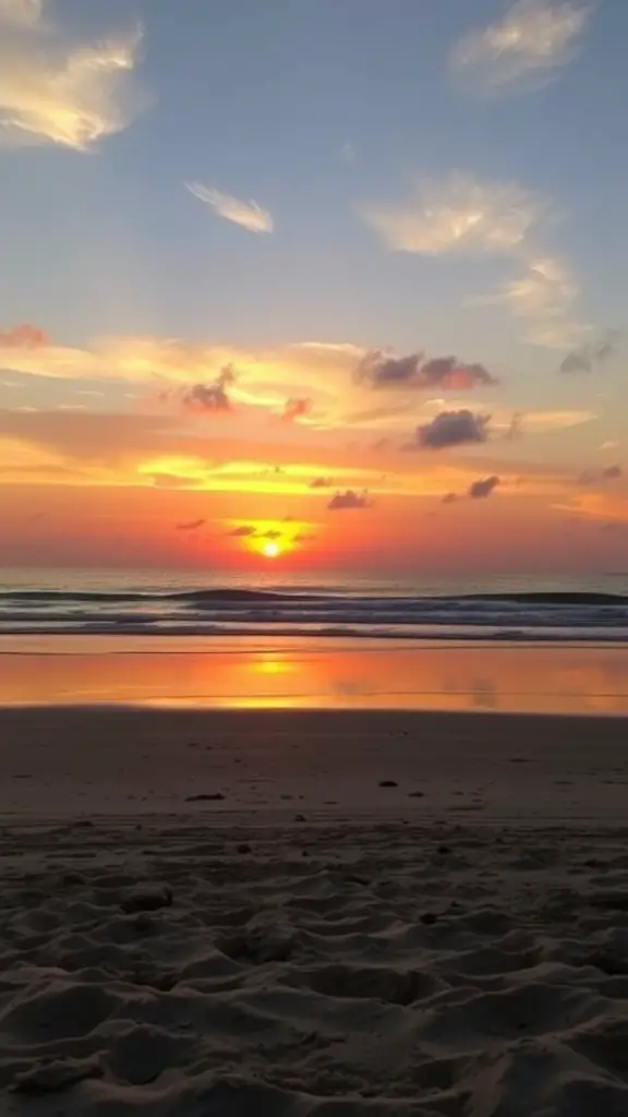 21 Coastal Baby Shower Theme Ideas You’ll Love 11 A beautiful sunset over a beach with soft clouds and gentle waves.