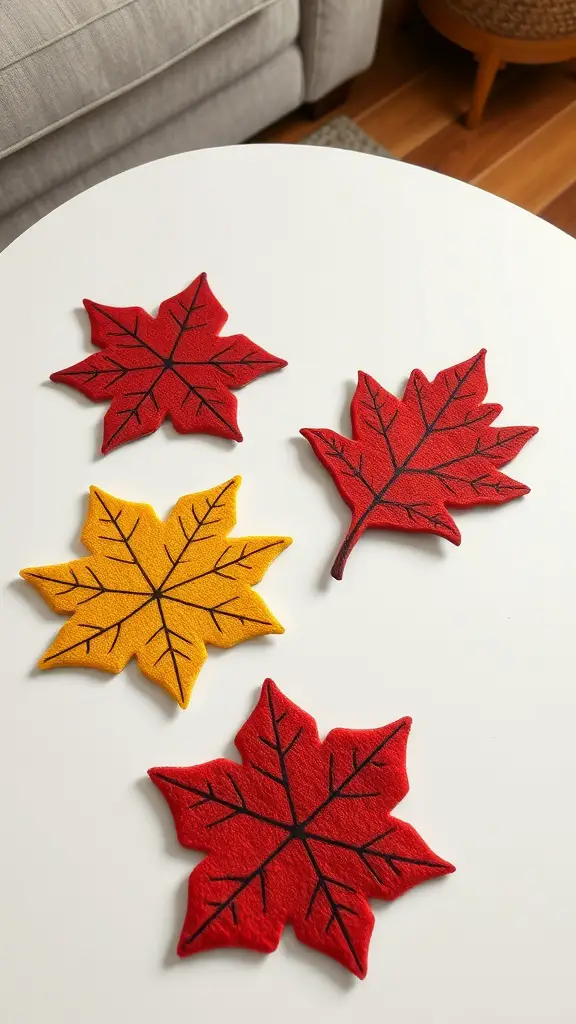 25+ Must-Try Fall Crafts for Adults 11 Colorful felt leaf coasters in red and yellow on a white table.
