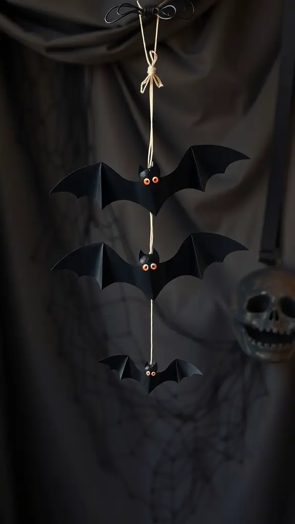 27+ Fun Halloween Crafts for Kids to Spook Up Your Season 10 A bat mobile made of black paper bats with orange eyes, hanging from a string.