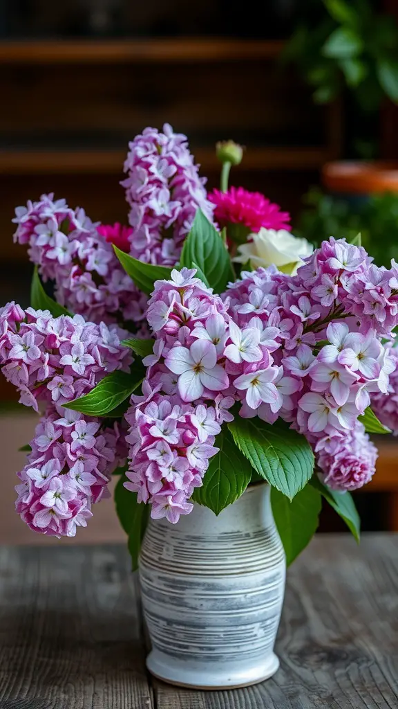 19+ Stunning Lilac Bush Landscaping Ideas for Your Garden 16 A bouquet of lilacs in a vase, showcasing their vibrant purple flowers and green leaves.