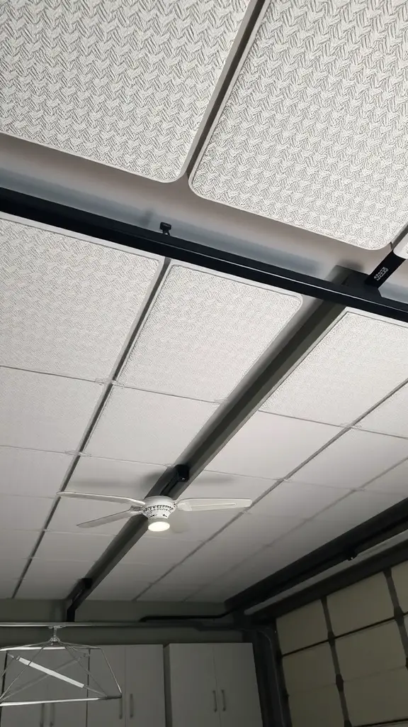 Acoustic panels installed on a garage ceiling with a ceiling fan