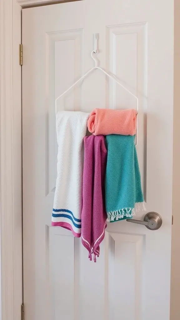 Colorful towels hanging on a door using a simple towel organizer