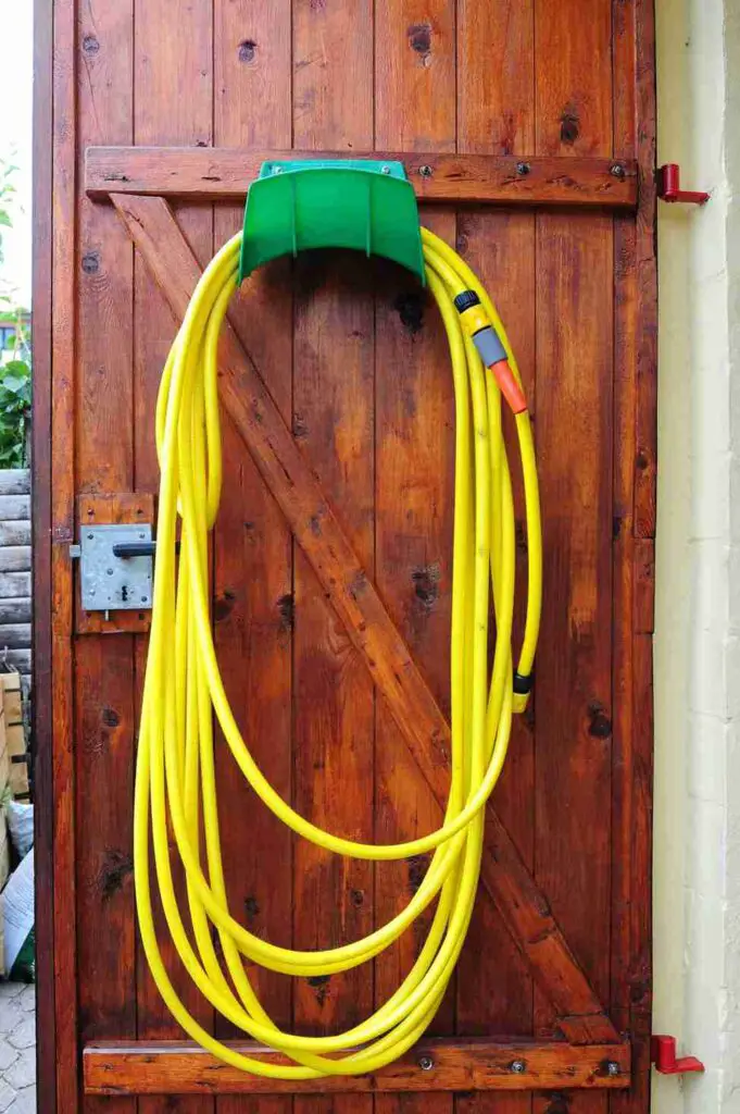 15 Stylish and Functional Garden Hose Hangers You Need in Your Yard 5