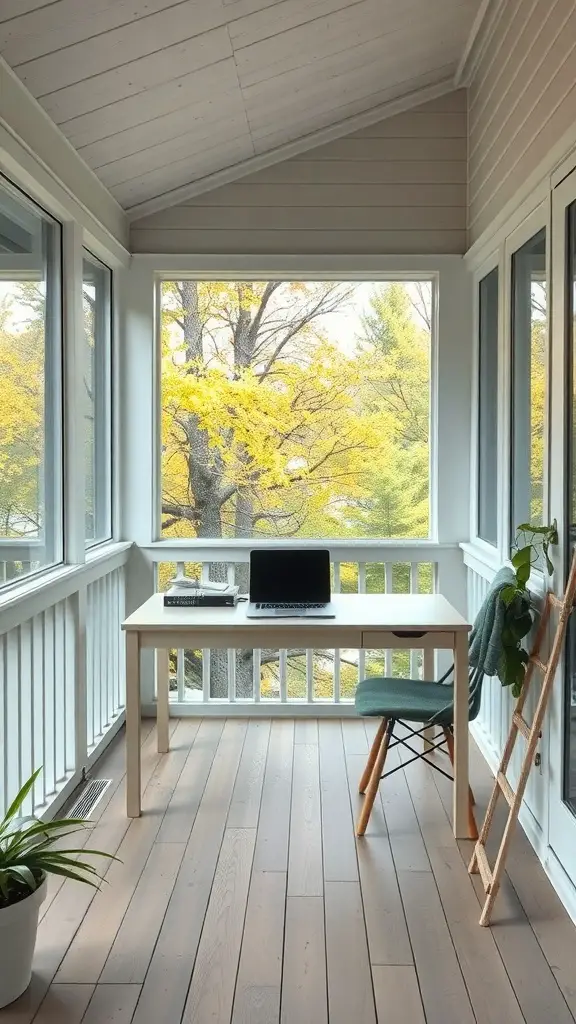 A small screened-in porch with a desk, laptop, and plants, overlooking trees with fall colors.