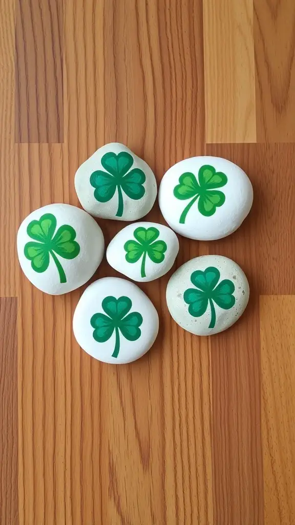 Hand-painted rocks with shamrock designs on a wooden surface