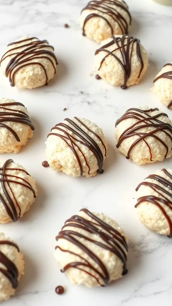 Coconut macaroons drizzled with chocolate on a marble surface.