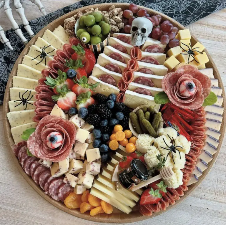 39 Spooky Charcuterie Board Ideas For Your Next Halloween Party 4 Spooky salami rose charcuterie board with cheese, berries, grapes, olives, pickles, and candy eyeballs