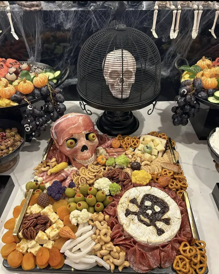 39 Spooky Charcuterie Board Ideas For Your Next Halloween Party 11 Haunted skull party charcuterie board with cheese, olives, crackers, vegetables, nuts, meats, and pretzels