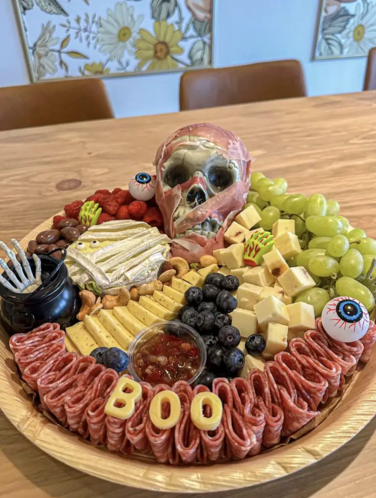 39 Spooky Charcuterie Board Ideas For Your Next Halloween Party 15 Boo Halloween charcuterie board with salami, cheese, grapes, berries, crackers, dip, and a skull