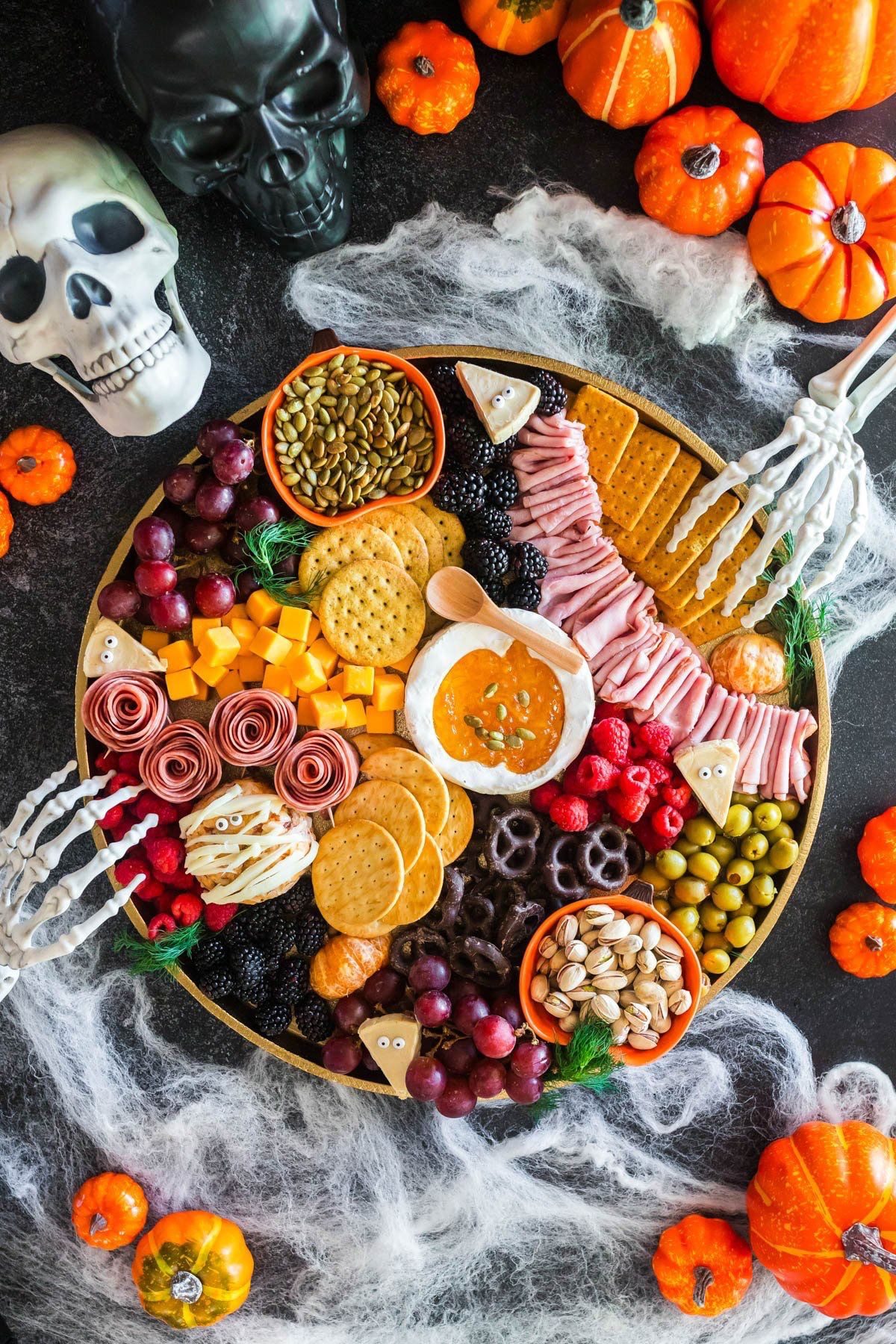 39 Spooky Charcuterie Board Ideas For Your Next Halloween Party 16 Pumpkin dip Halloween charcuterie board with cheese, meat, crackers, berries, grapes, olives, nuts, and pretzels