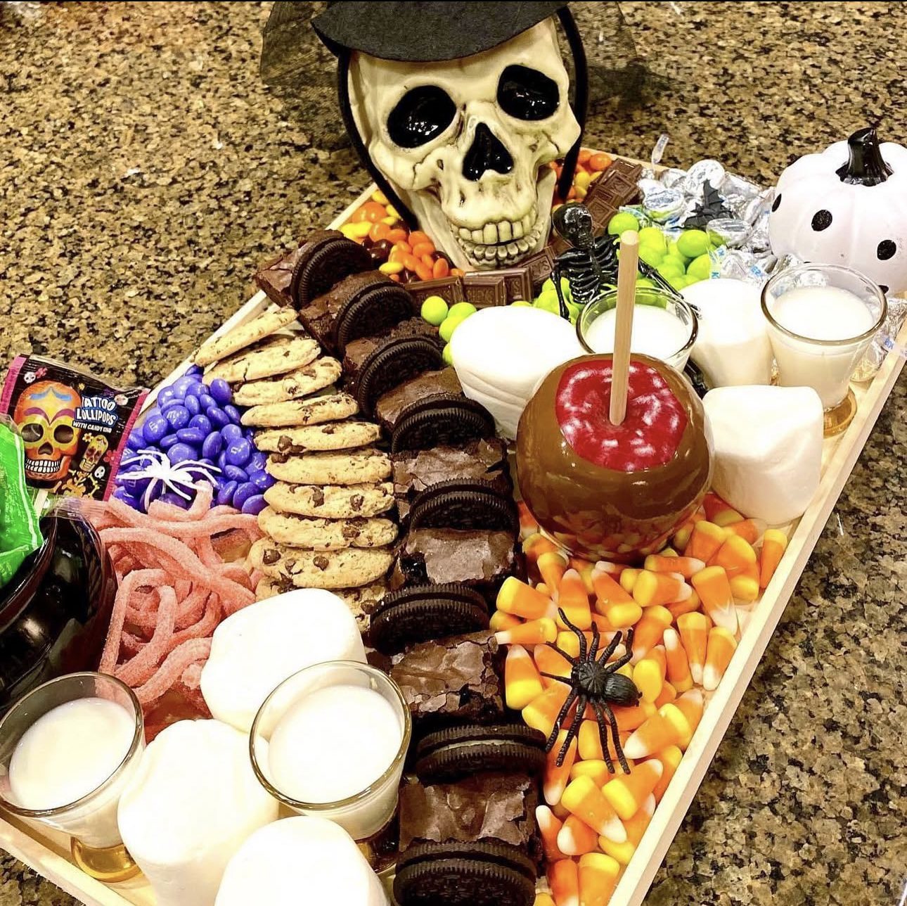 41 Spooky Dessert Board Ideas for Halloween Parties 5 Halloween dessert board with caramel apple, cookies, brownies, marshmallows, and candy corn
