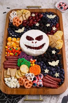 41 Spooky Dessert Board Ideas for Halloween Parties 10 Halloween snack board with ghost cheeseball, crackers, fruit, cheese, salami, and pretzels