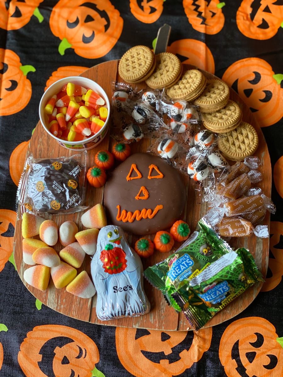 41 Spooky Dessert Board Ideas for Halloween Parties 13 Simple Halloween candy board with cookies, candy corn, caramel, chocolate treats, and pumpkin candies