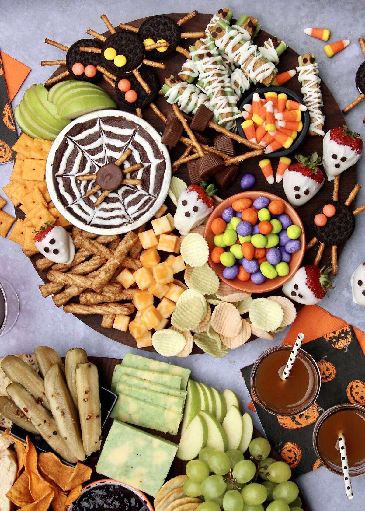 41 Spooky Dessert Board Ideas for Halloween Parties 17 Sweet and savory Halloween board with chocolate dip, ghost strawberries, Oreo spiders, fruit, crackers, cheese, and candy