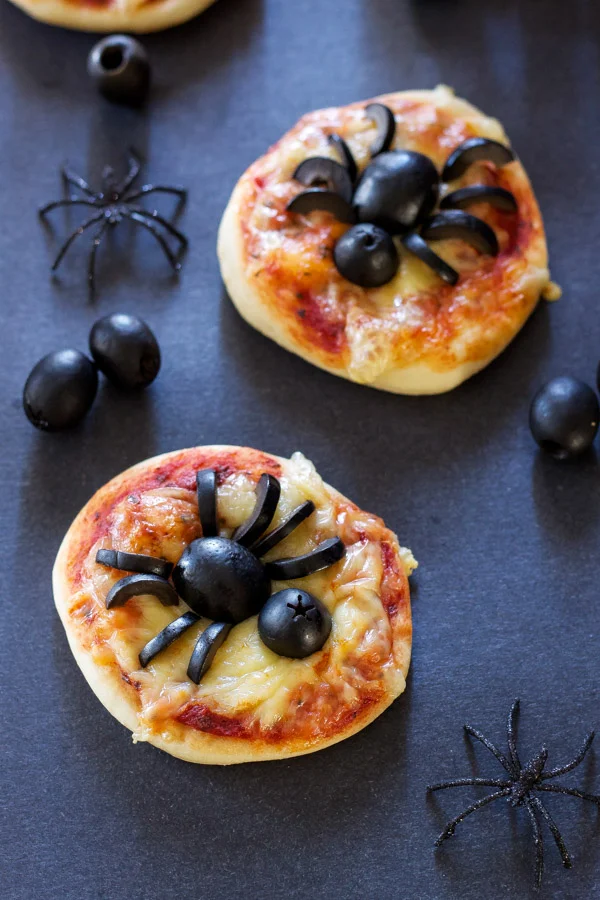 27 Halloween Treats for Kids and Adults That Everyone Will Love 5 Mini cheese pizzas decorated with black olive spiders