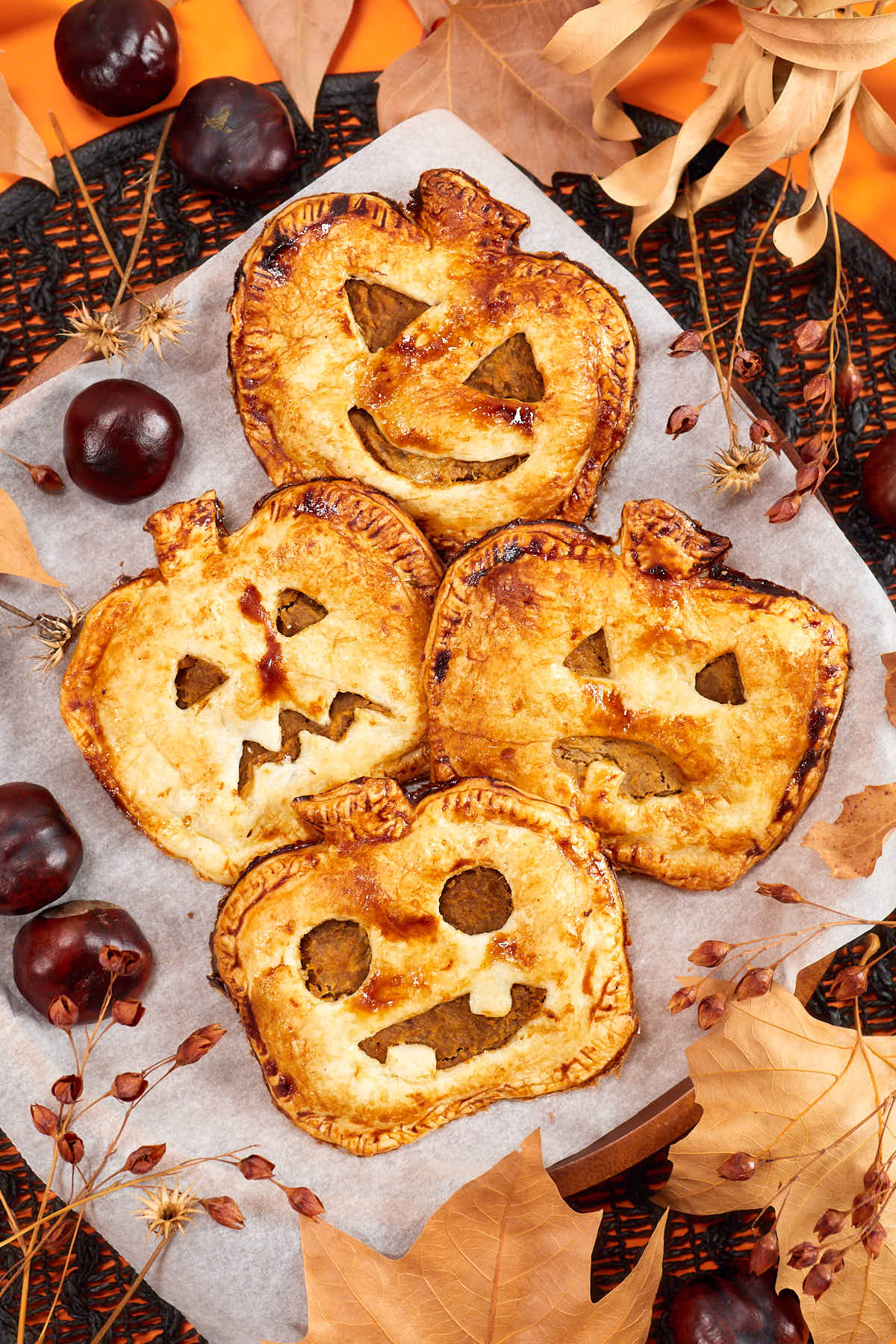 27 Halloween Treats for Kids and Adults That Everyone Will Love 6 Pumpkin shaped hand pies with carved Halloween faces
