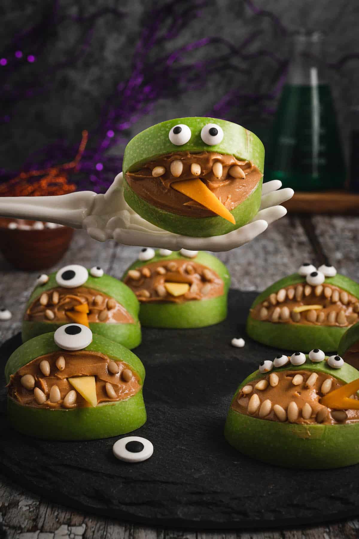 27 Halloween Treats for Kids and Adults That Everyone Will Love 9 Green apple monster snacks filled with peanut butter