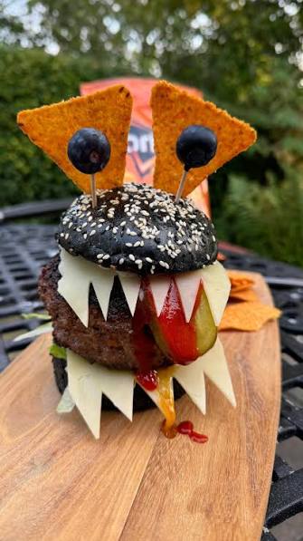 27 Halloween Treats for Kids and Adults That Everyone Will Love 13 Monster Halloween burger with cheese teeth and blueberry eyes