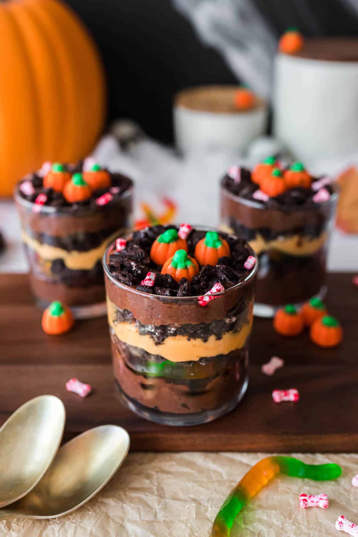 27 Halloween Treats for Kids and Adults That Everyone Will Love 14 Layered Halloween dirt dessert cups with candy pumpkins