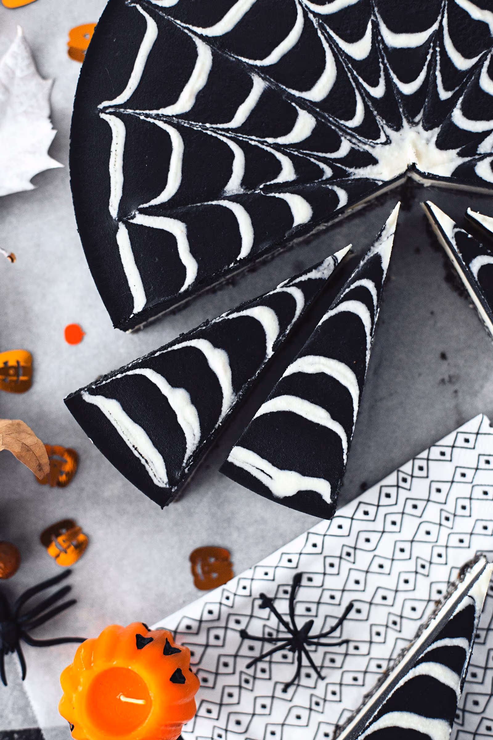 27 Halloween Treats for Kids and Adults That Everyone Will Love 17 Black Halloween cake decorated with a white spider web pattern