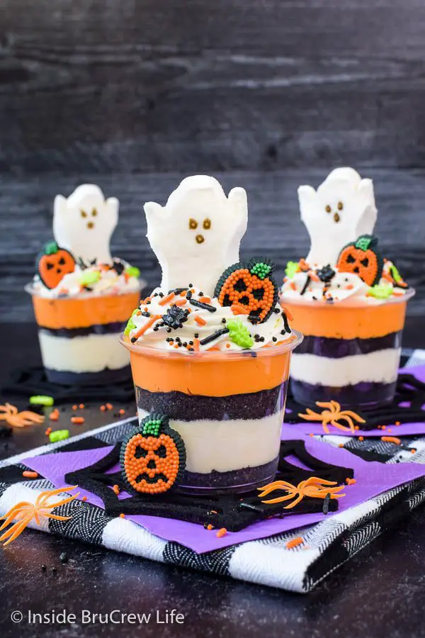 27 Halloween Treats for Kids and Adults That Everyone Will Love 18 Layered Halloween parfait cups topped with ghost cookies