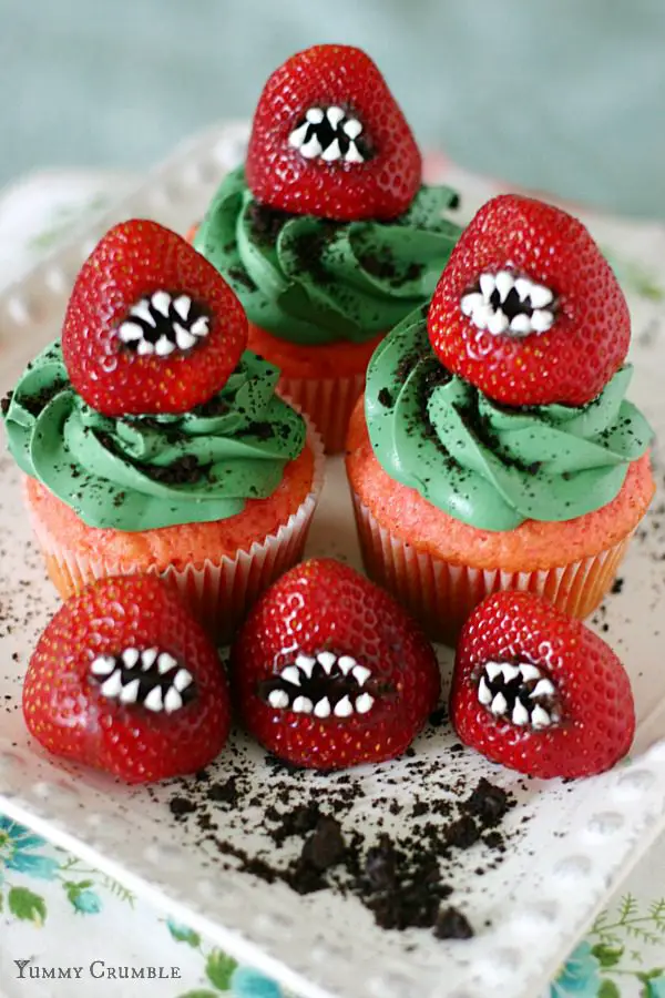27 Halloween Treats for Kids and Adults That Everyone Will Love 20 Strawberry monster cupcakes with green frosting and candy teeth