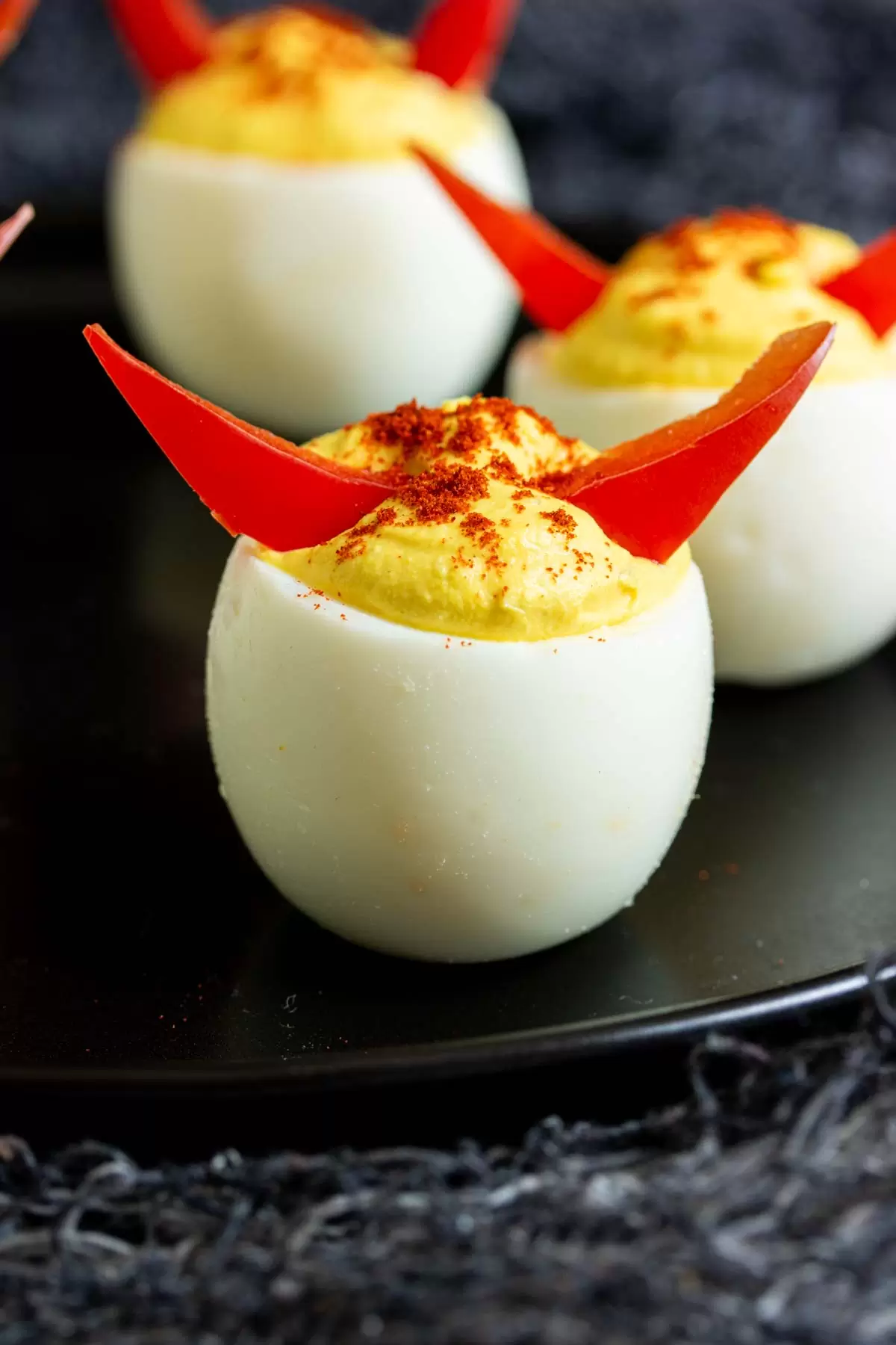 27 Halloween Treats for Kids and Adults That Everyone Will Love 21 Halloween deviled eggs decorated with red pepper horns
