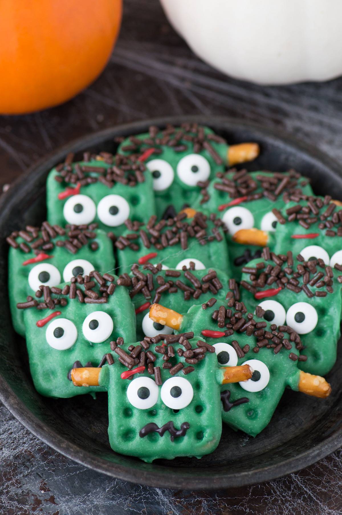27 Halloween Treats for Kids and Adults That Everyone Will Love 24 Green Frankenstein chocolate covered crackers with candy eyes
