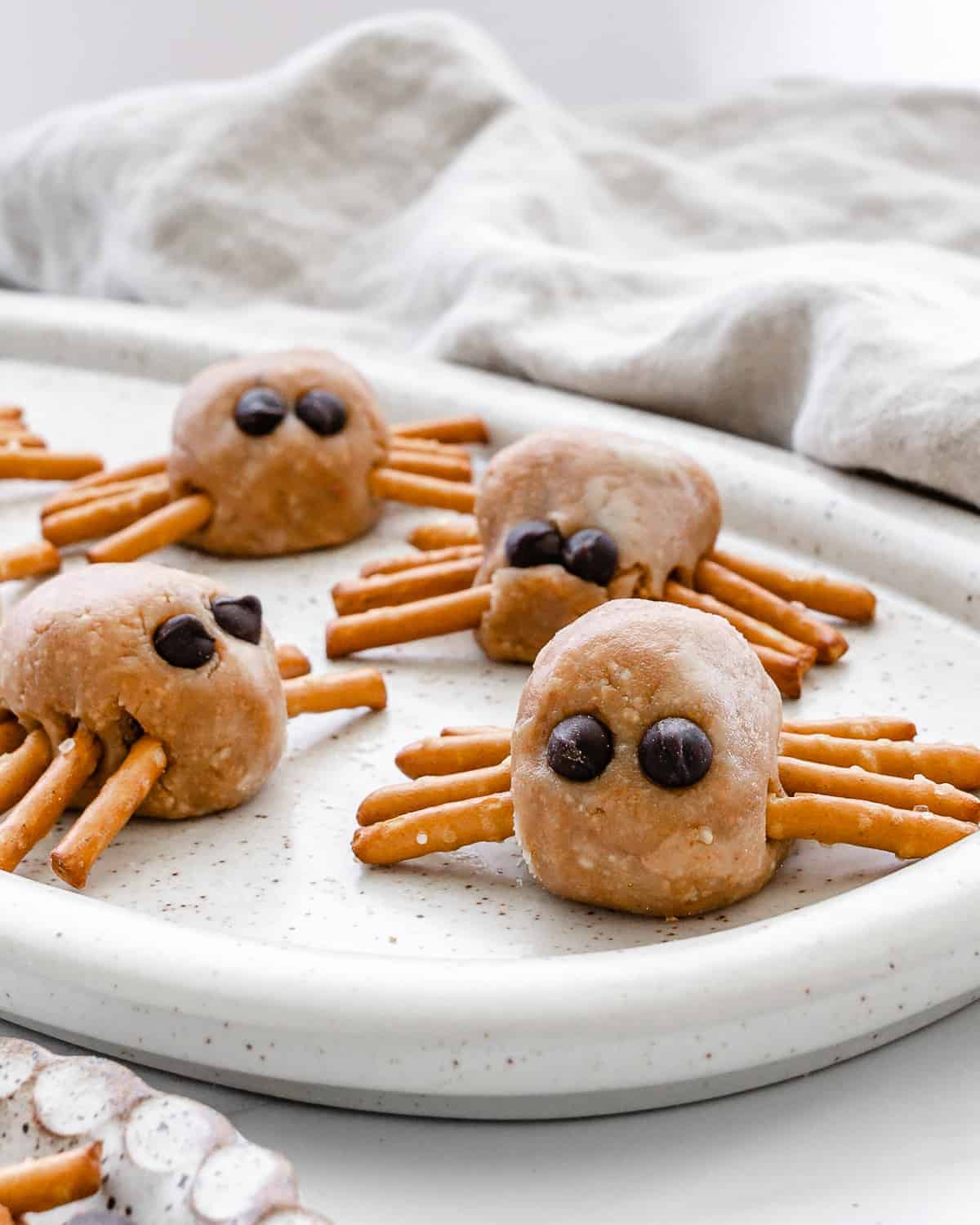 27 Halloween Treats for Kids and Adults That Everyone Will Love 26 Peanut butter spider bites with pretzel legs and chocolate eyes