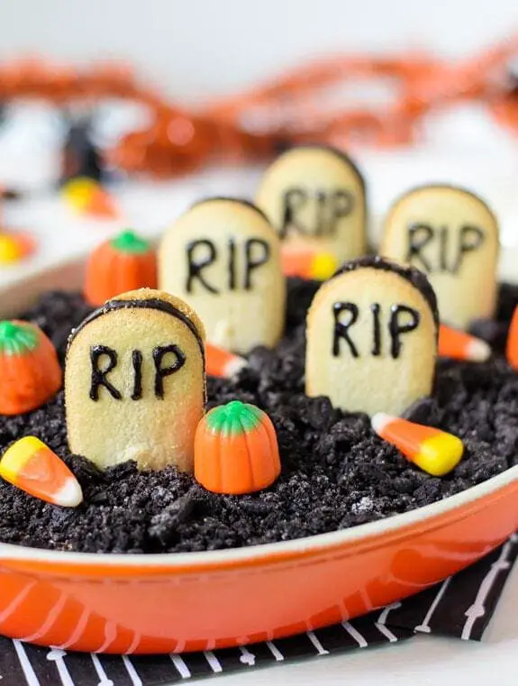 27 Halloween Treats for Kids and Adults That Everyone Will Love 27 Halloween graveyard dessert with cookie tombstones and candy pumpkins