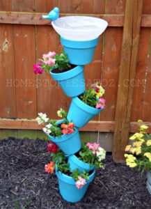 25 DIY Garden Art Sculptures to Add Personality to Your Yard 3 Tilted Terracotta Pot Tower