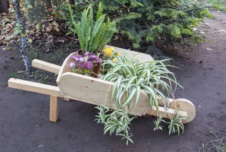 25 DIY Garden Art Sculptures to Add Personality to Your Yard 5 Wooden Wheelbarrow Planter