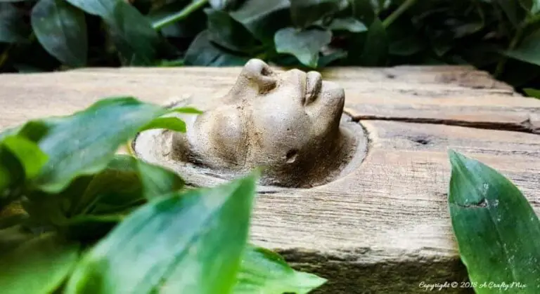 25 DIY Garden Art Sculptures to Add Personality to Your Yard 16 Sunken Concrete Face Plaque