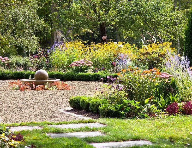 Gravel Patio with Flower Borders and Water Feature
