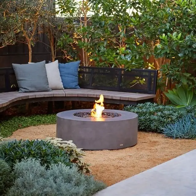 21 Garden Fire Pits That Create the Perfect Backyard Gathering Spot 15 Modern Curved Bench Fire Bowl