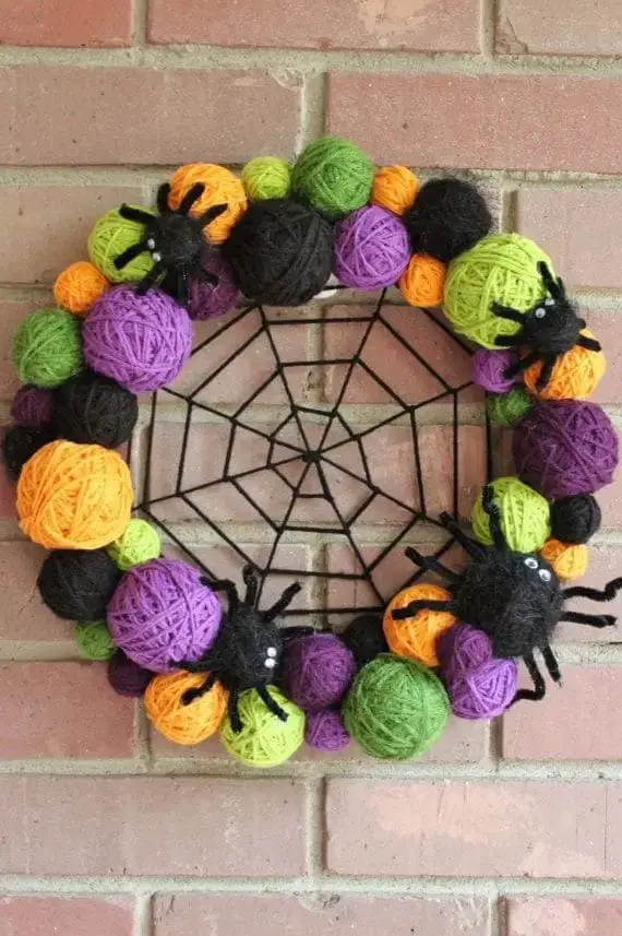 27 Halloween Wreath Ideas to Give Your Front Door a Spooky Touch 3 Yarn Ball Spider Wreath