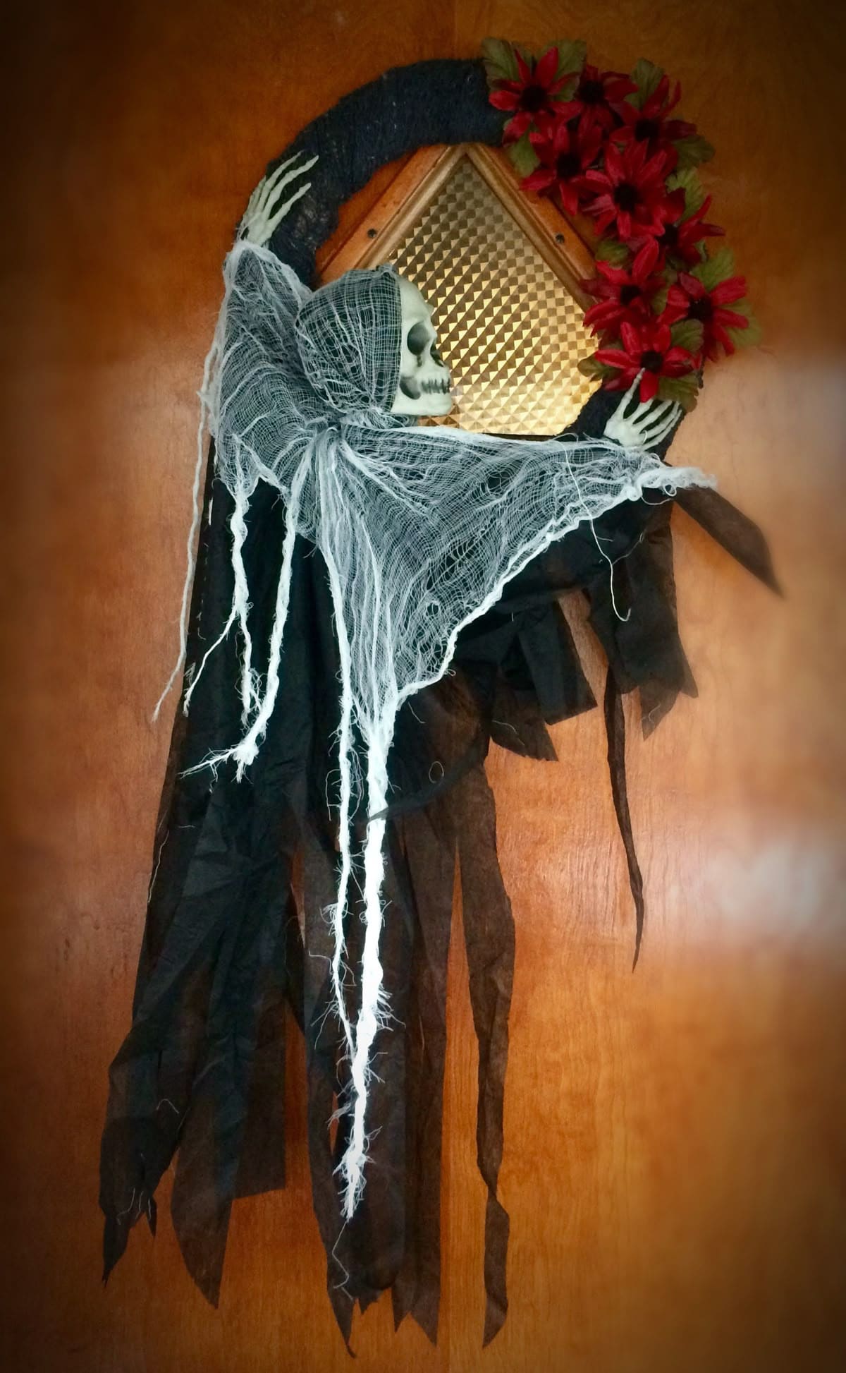 27 Halloween Wreath Ideas to Give Your Front Door a Spooky Touch 18 Grim Reaper Crescent Wreath
