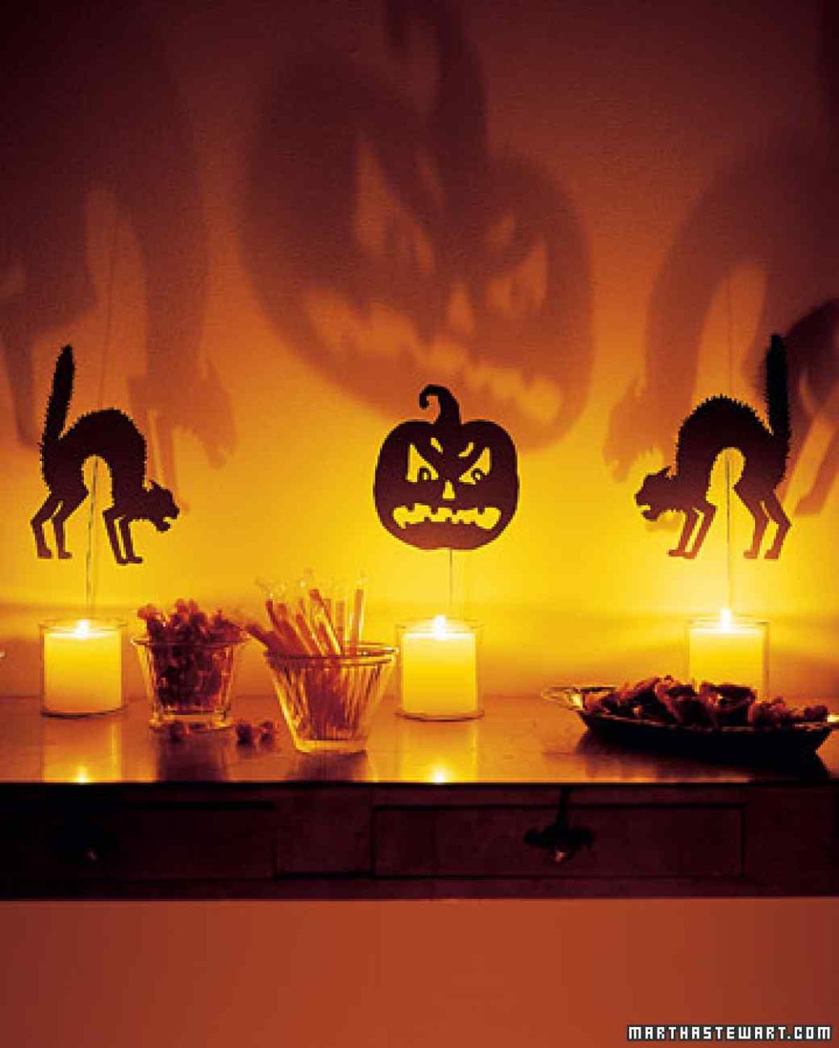 31 Indoor Halloween Decorations Ideas to Make Your Home Spooktacular 2 Shadow Puppet Candle Display