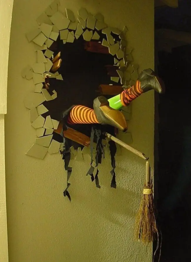 31 Indoor Halloween Decorations Ideas to Make Your Home Spooktacular 8 Crashed Wall Witch Legs