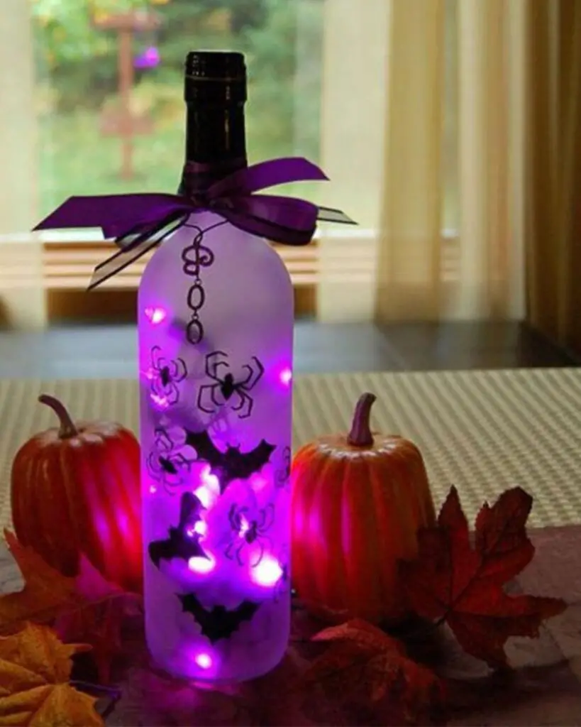 31 Indoor Halloween Decorations Ideas to Make Your Home Spooktacular 9 Glowing Wine Bottle Centerpiece