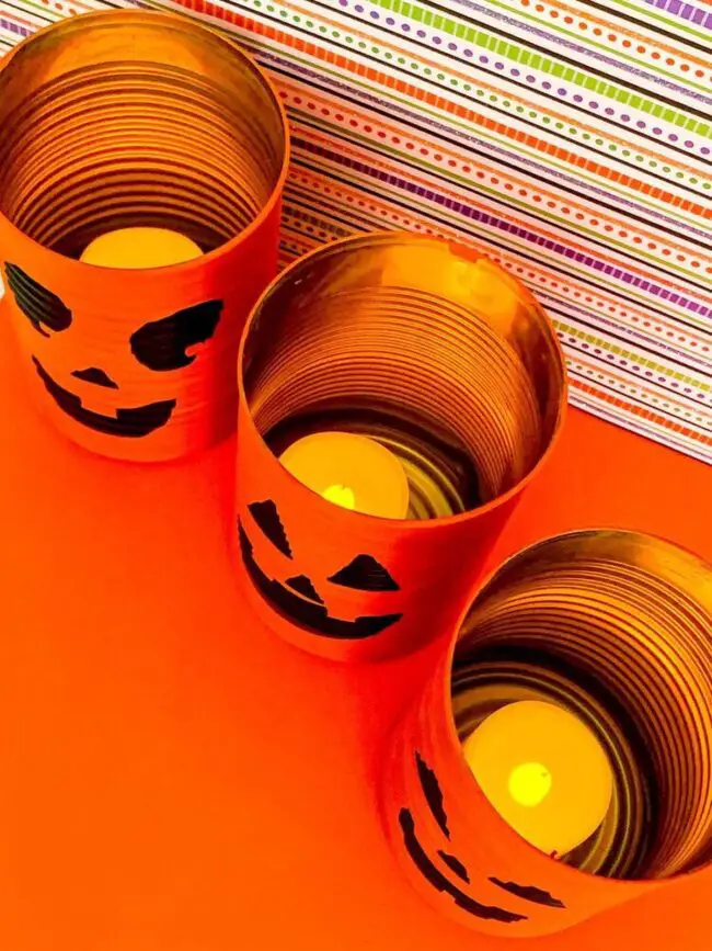31 Indoor Halloween Decorations Ideas to Make Your Home Spooktacular 16 Upcycled Tin Can Jack-o-Lanterns
