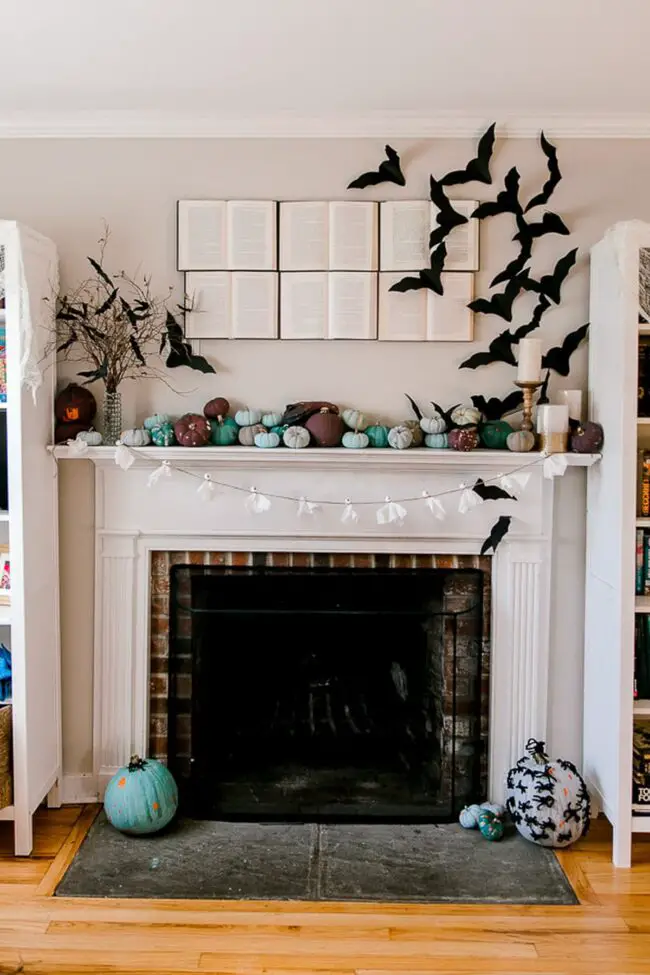 31 Indoor Halloween Decorations Ideas to Make Your Home Spooktacular 24 Bookish Bat Fireplace Mantle