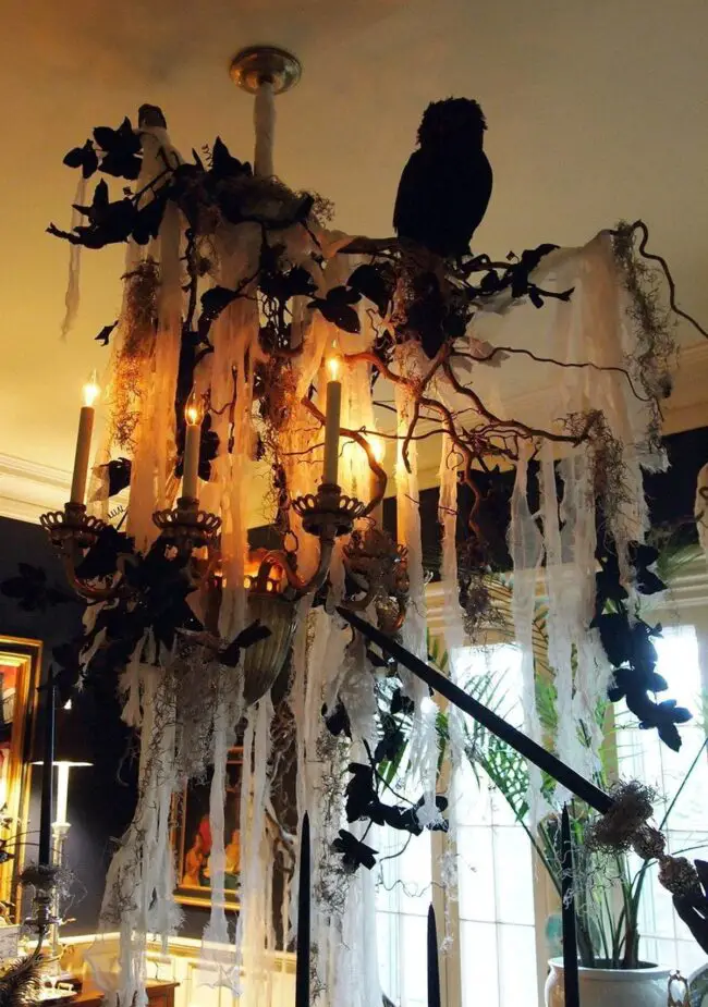 31 Indoor Halloween Decorations Ideas to Make Your Home Spooktacular 28 Cobwebbed Raven Chandelier