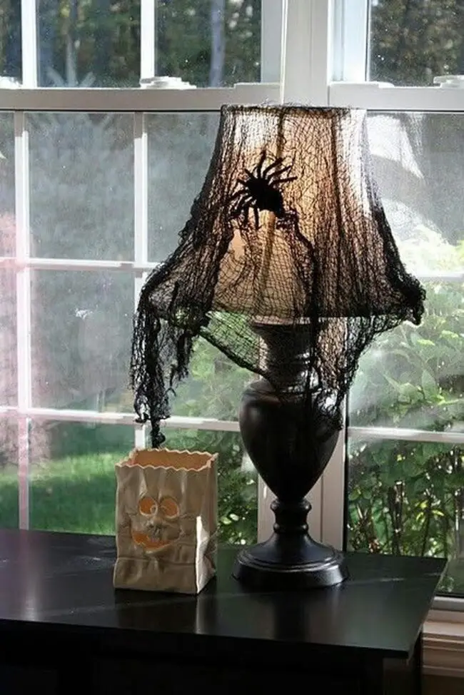 31 Indoor Halloween Decorations Ideas to Make Your Home Spooktacular 29 Spiderweb Lampshade Cover