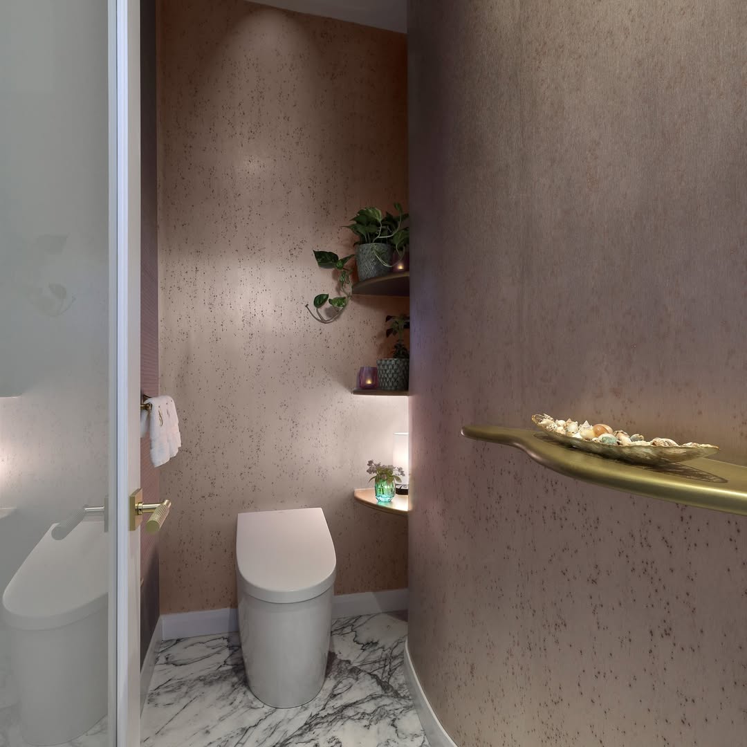 25 Small Toilet Room Ideas to Make a Tiny Space Feel Stylish 5 Metallic Rose Gold Walls with Soft Corner Lighting