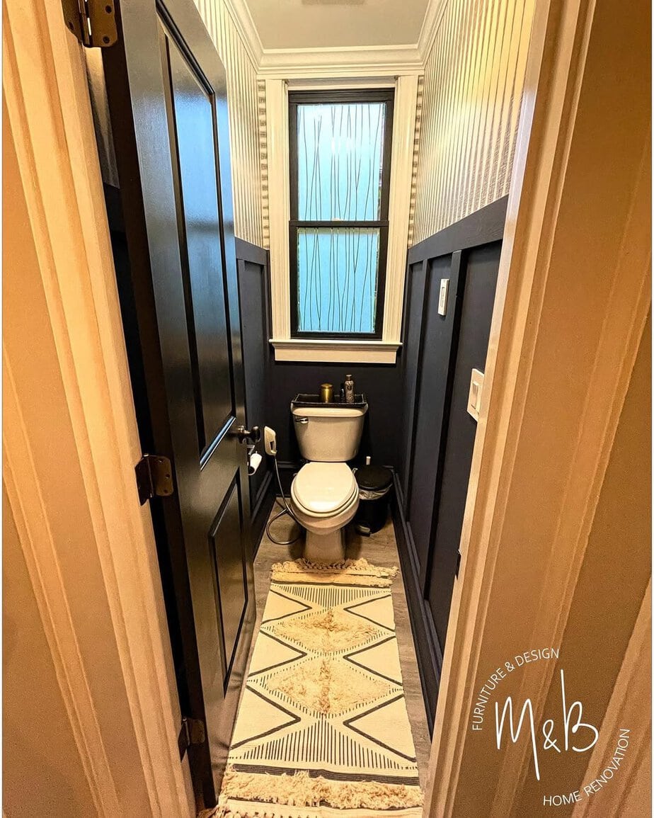 25 Small Toilet Room Ideas to Make a Tiny Space Feel Stylish 12 Dark Navy Lower Paneling with Striped Upper Wallpaper