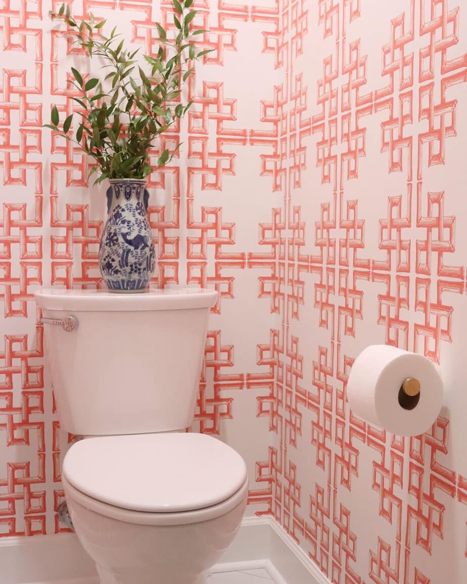 25 Small Toilet Room Ideas to Make a Tiny Space Feel Stylish 14 Vibrant Coral Geometric Wallpaper Accent